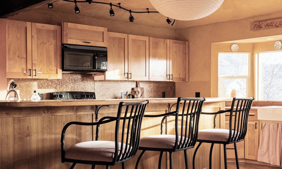 Cornville House | A dual-suite boutique retreat featuring the light-filled Sunshine Suite and the secluded Garden Room, set within a lush, wild landscape.