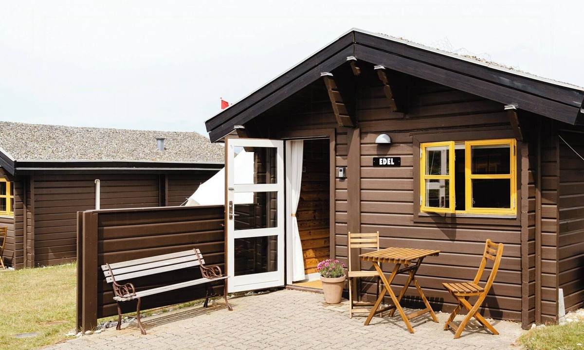 Fjand Badeby House | A small wooden hut in a large community