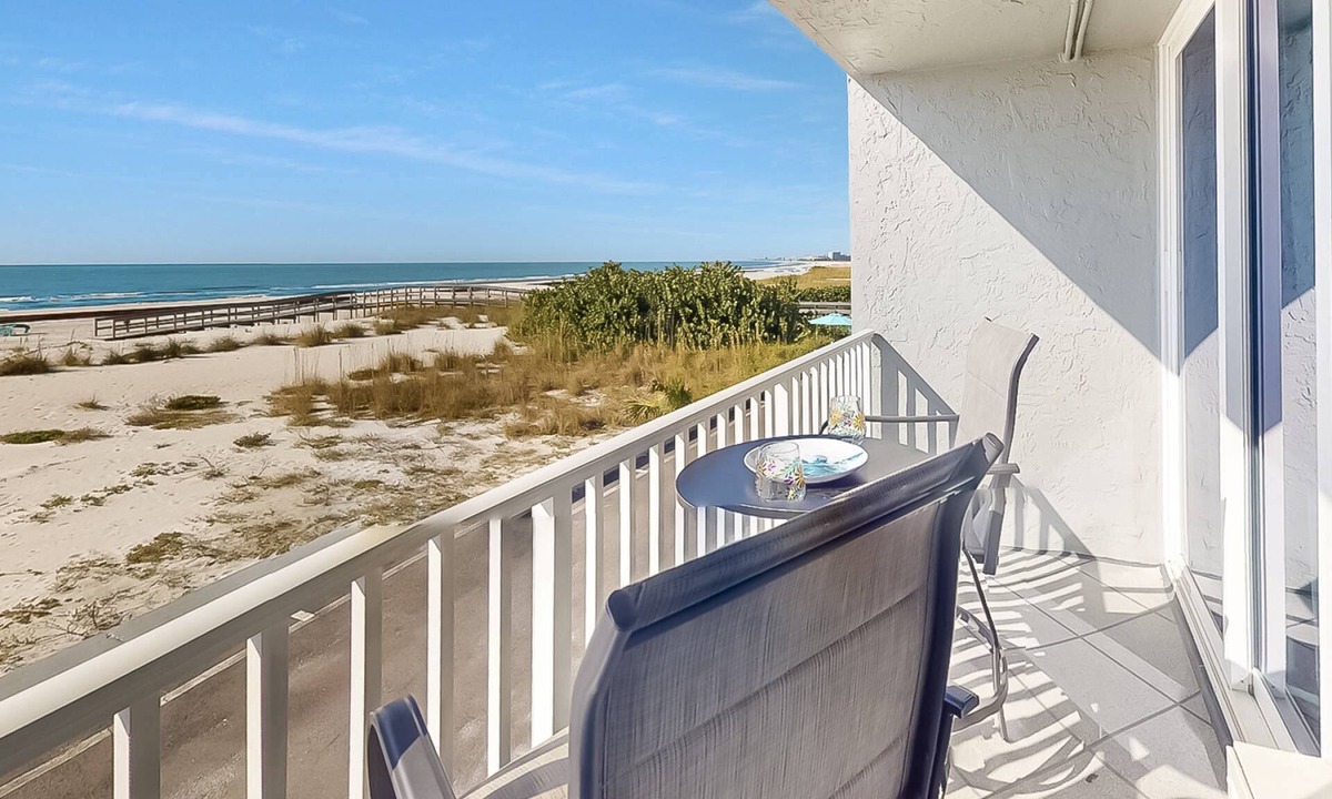 Treasure Island Condo | Beachfront Balcony ~ View of Treasure Island Beach ~ Heated Pool, Tiki Bar, BBQ Grills, Volleyball.