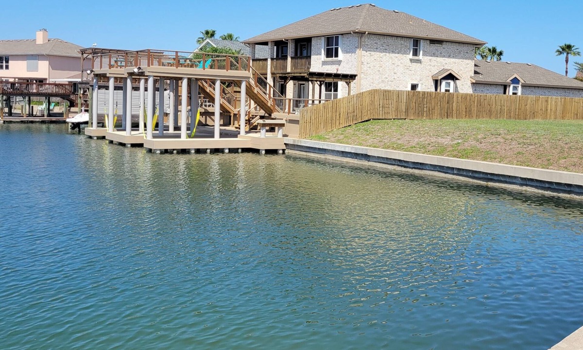 Corpus Christi House | Bottom Level Canal Water Front Home with Spacious Deck, Boat Dock, and Parking!