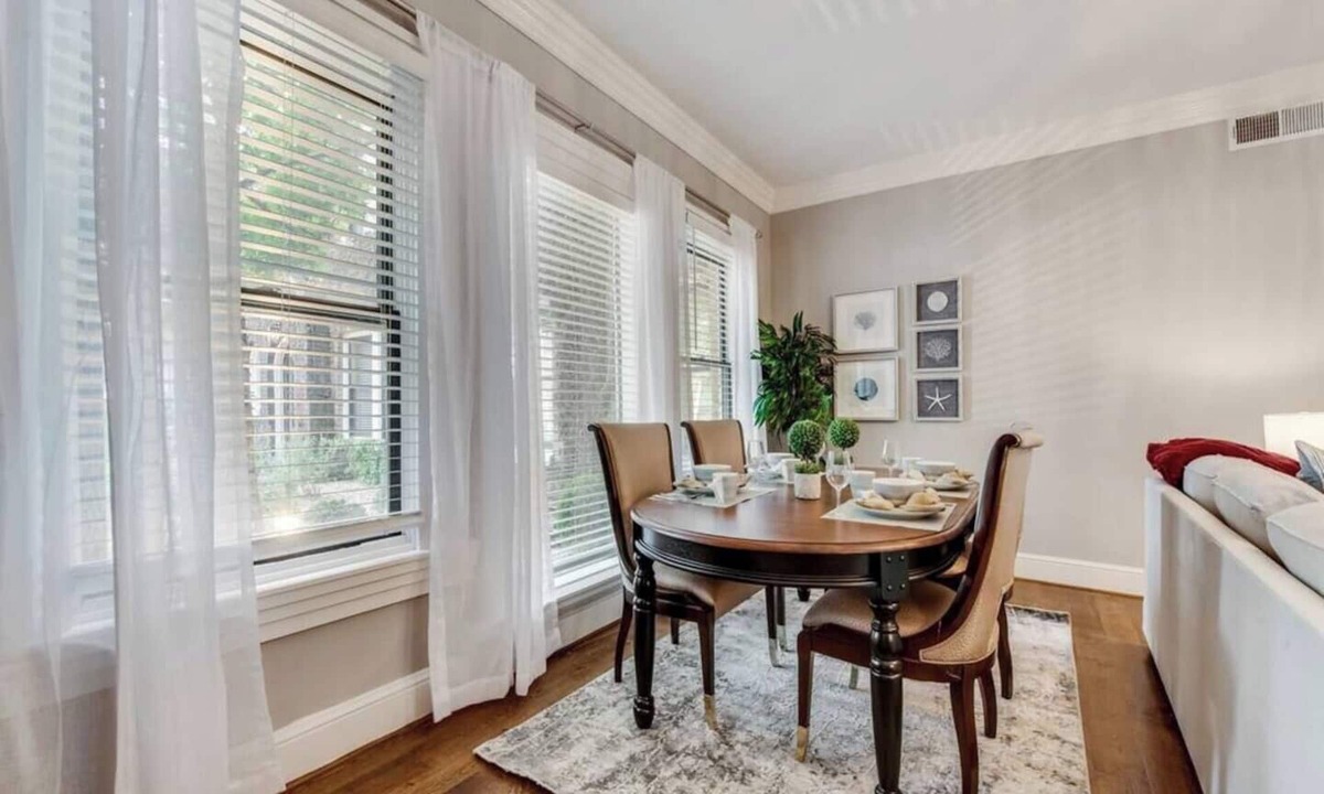 Old East Dallas Condo | Bright 1-bedroom condo combining historic charm with modern comfort. Features a spacious living area with elegant furnishings, crystal lighting, and abundant natural light for a refined Dallas stay.