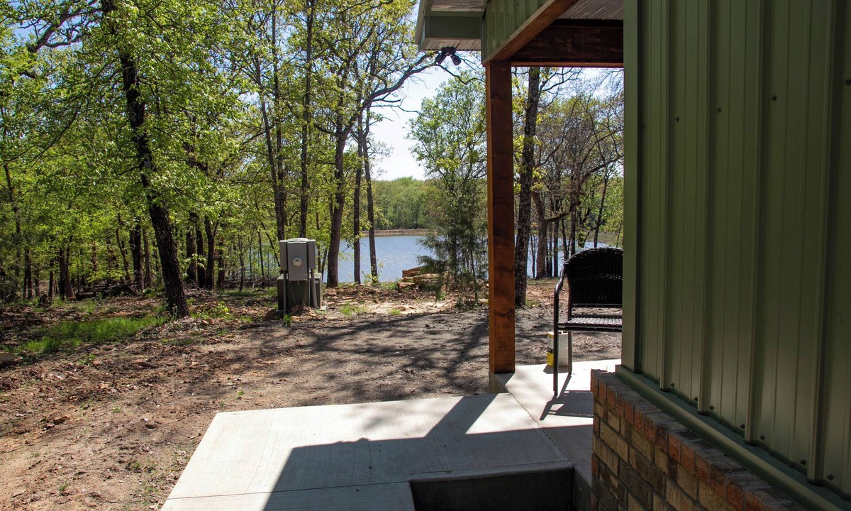 Carlisle Cabin | Cabin Bunkhouse with Hot Tub on Private Lake, Fire Pit & Swings in Vian, OK!