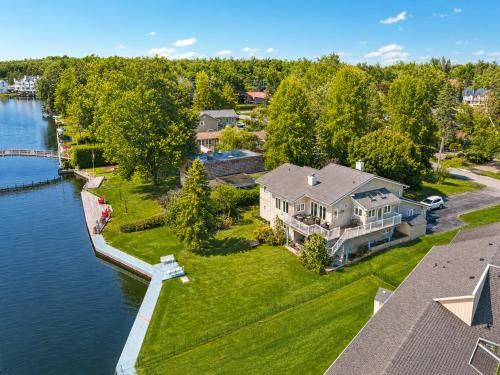 Lagoon City House | Canalside Summer Cottage with Waterview, Custom Bar, BBQ, and Fireplace