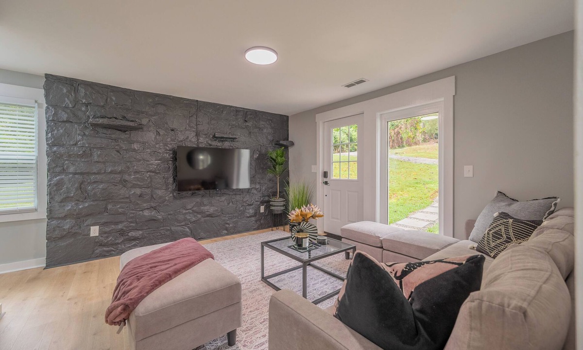 Blacksburg House | Charming entry and spacious back deck surrounded by nature, perfect for a peaceful getaway.