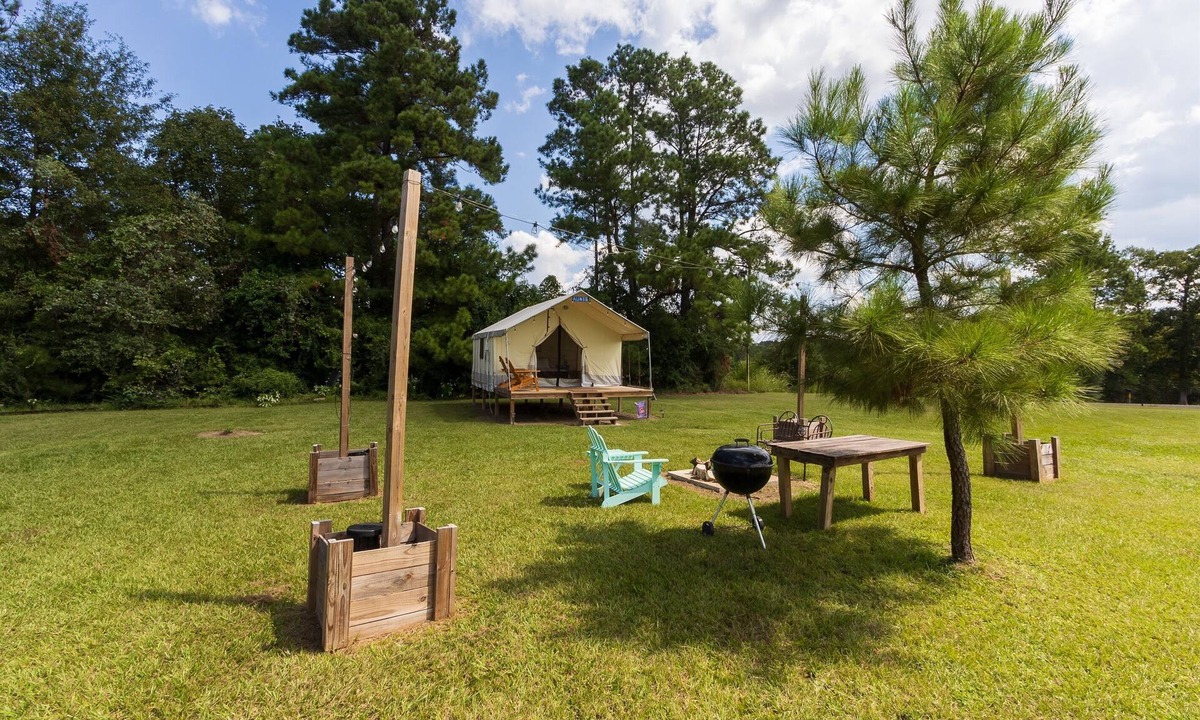 Coldspring RV Rental | Cozy Forest Retreat: Snug Glamping by the Fire Pit