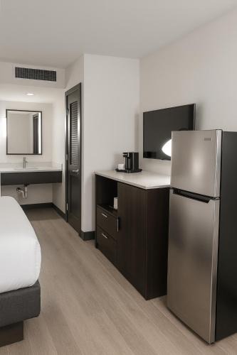 Wheatland Hotel | DELSOL Hotel Suites OKC Airport, Event Center, indoor Pool and Kids Arcade, 5 Min from Paycom, Fairgrounds