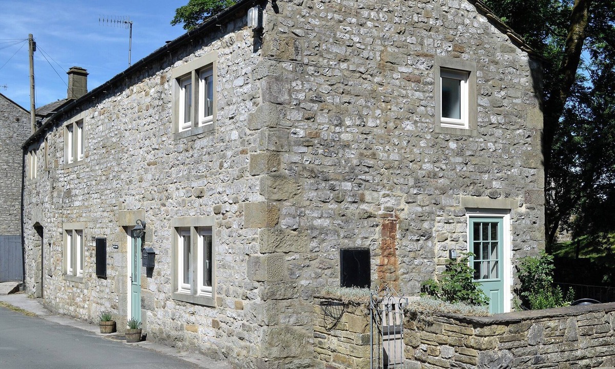 Kettlewell Cottage | Detached barn conversion with side terrace overlooking the river.