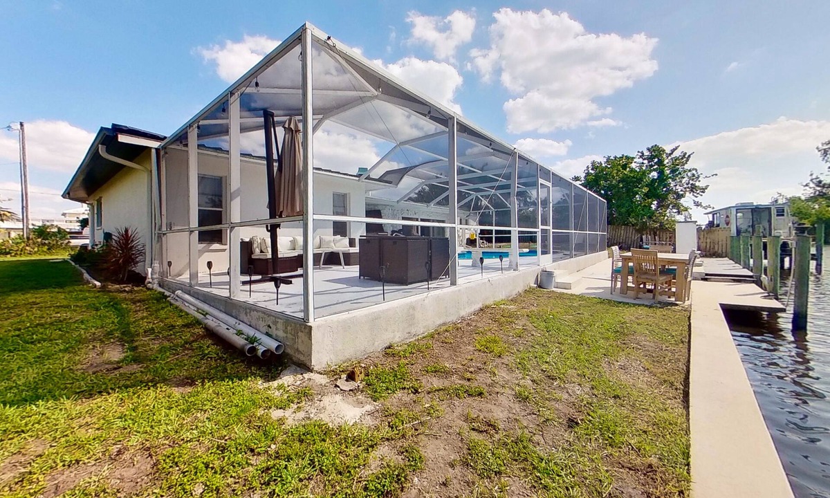Fort Myers House | Dog-friendly home with private pool, dock, fireplace, patio, grill, & canal view