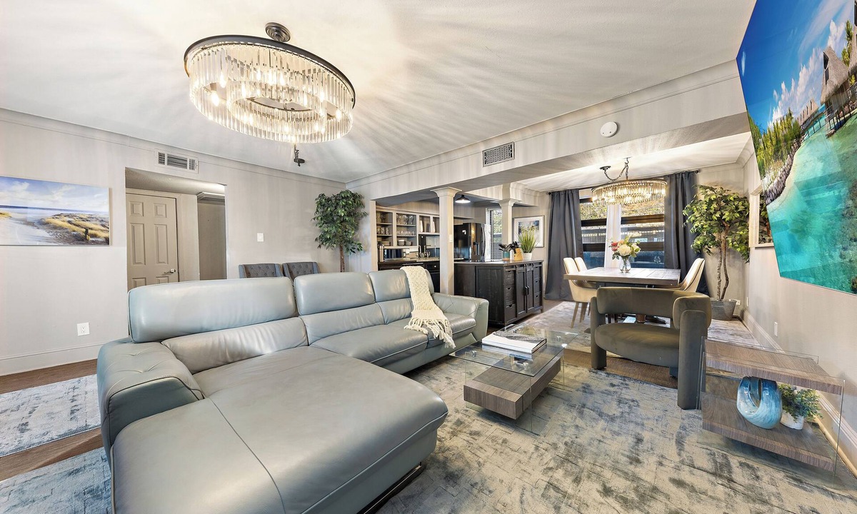 Old East Dallas Condo | Experience elevated comfort in this upscale 2-bedroom Dallas condo with pool views and exclusive access to an award-winning courtyard featuring a resort-style pool, hot tub, dry sauna, and lush lounge areas. Enjoy a 77″ smart TV, sleek leather sofa,