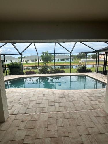 Pebble Beach House | Heated pool with canal views