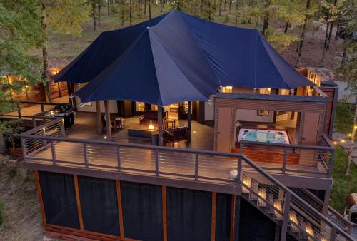 Mid America House | Hot Springs Retreat: Luxe Tented Cabin with Waterfront Views and Hot Tub
