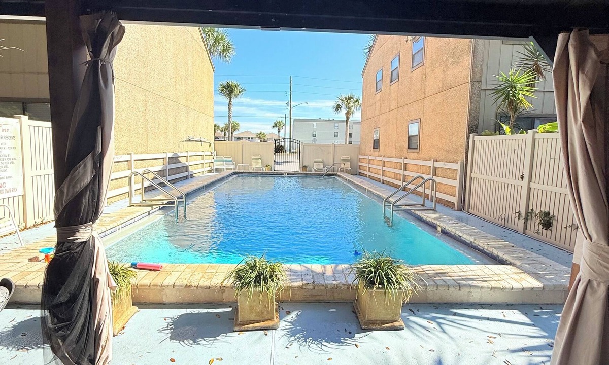 Fernandina Beach House | Latitude Adjustment-One block from the beach, shared pool, one dog allowed.