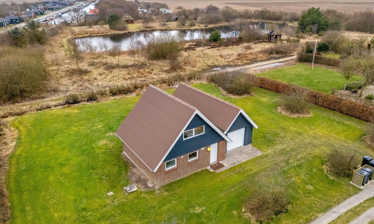 Skjern House | Lovely holiday home with a view of the fishing lake and the fjord.