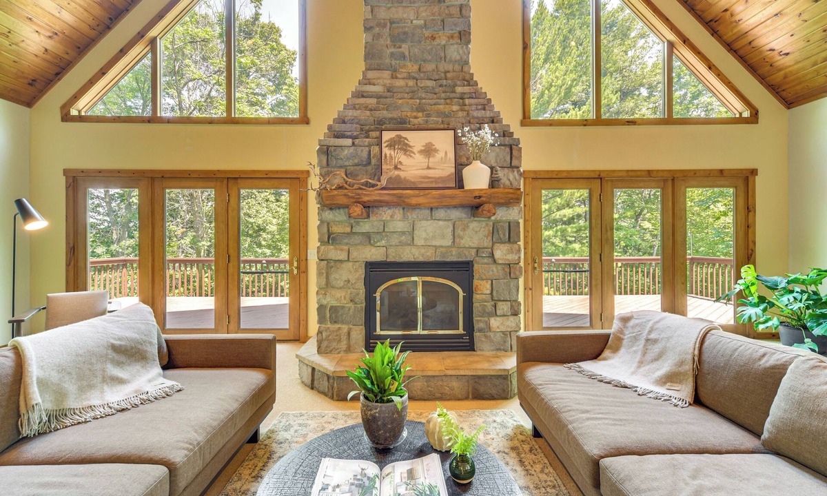 Amery House | NEW LISTING! Timber Ridge Lake House is a private lake home in Amery Wisconsin on Lake Wapogasset. The home balances the warmth of a large A-Frame with modern decor and finishes providing a serene stay with woods and lake views.