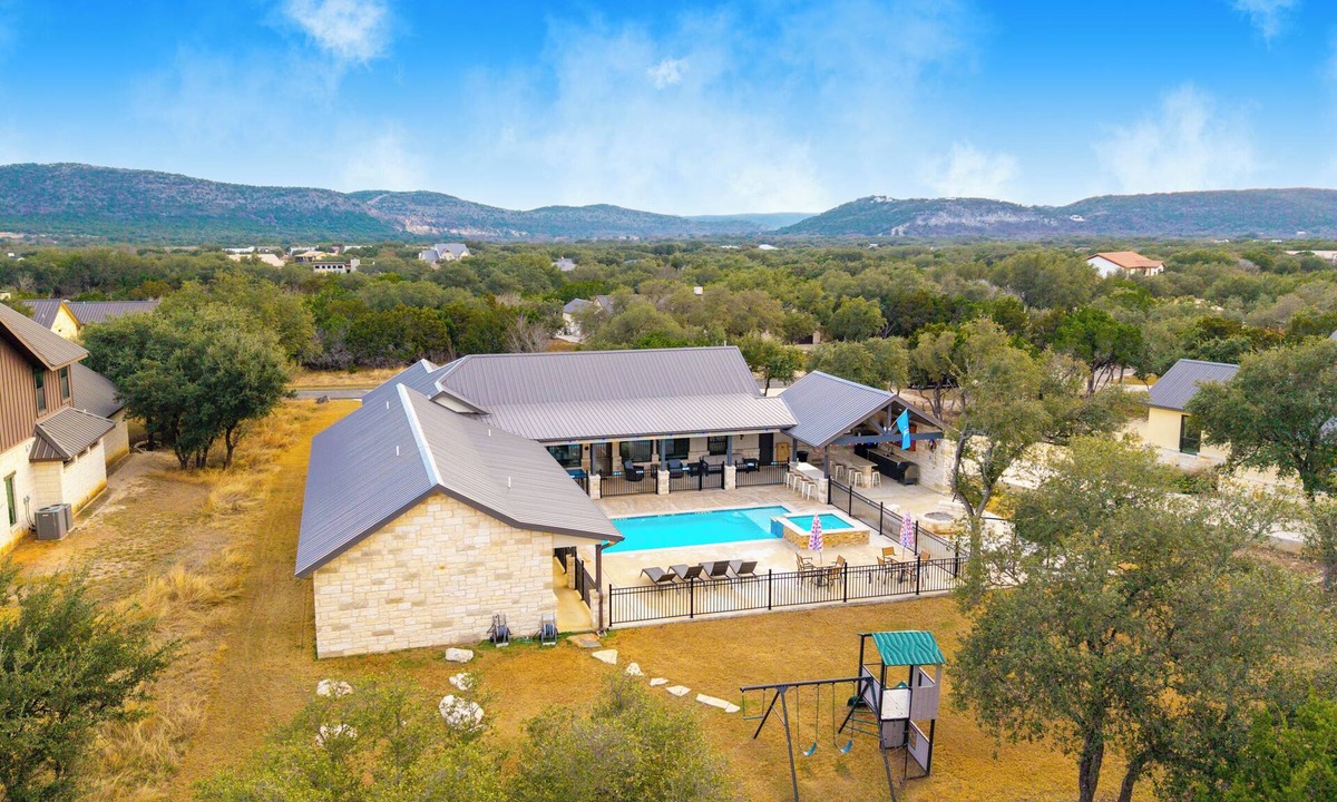 Sabinal House | NOLA styled 6-bedroom home in Concan. Sleeps 36 with AC, WiFi, Pool, Hot Tub