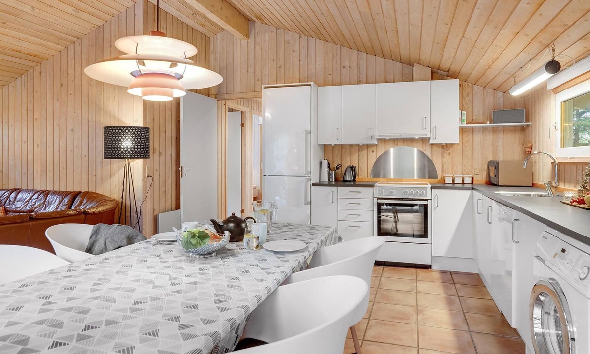 Vorupør House | On a hilly natural plot surrounded by trees, lies this beautiful wooden vacation home.