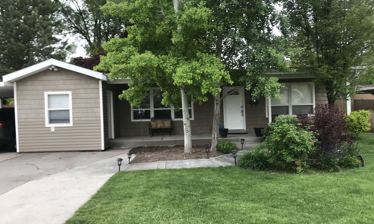 Millcreek House | Open floor plan with a covered patio and fenced yard.