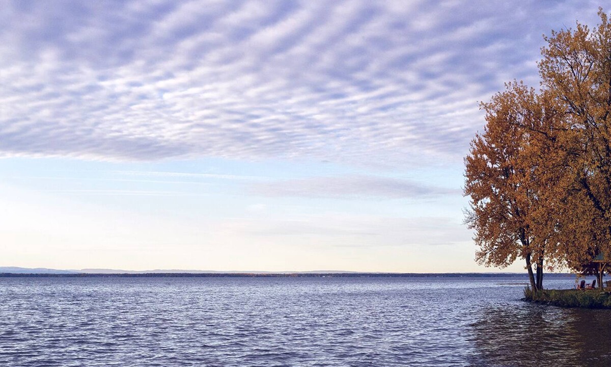 Bernhards Bay Cottage | Peaceful couples retreat on Oneida Lake. Insta-worthy views. Cozy interior.