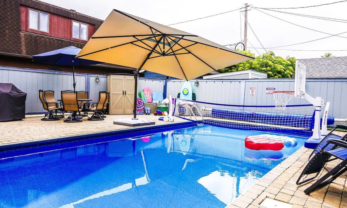 Huron House | Private heated pool in back & Sandy beach in front