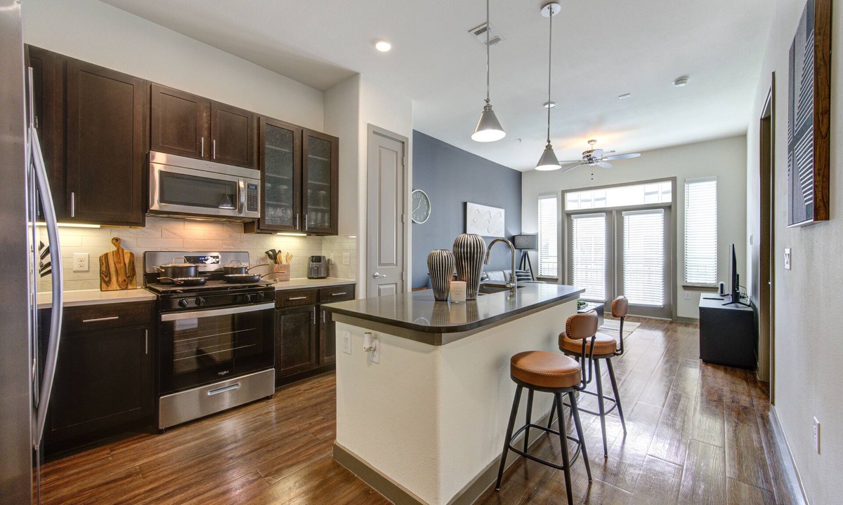 Energy Corridor Apartment | Stunning 1bd suite with warm and bold interiors, great amenities, & a pool view.