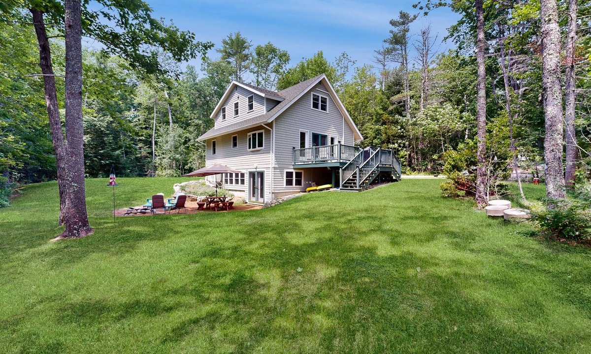 Warren House | Sunny, lakefront home on South Pond with private dock, great deck & firepit