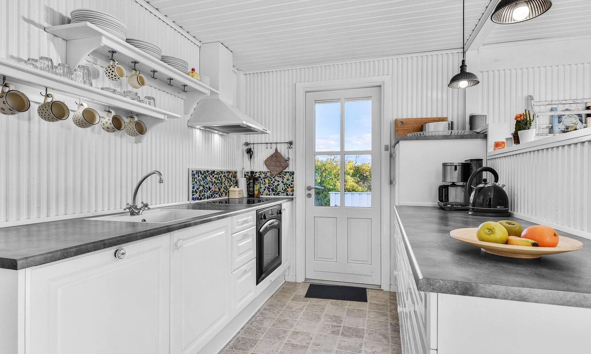 Ebberup House | This cozy cottage with a panoramic view of the sea is located just a few steps from the water.