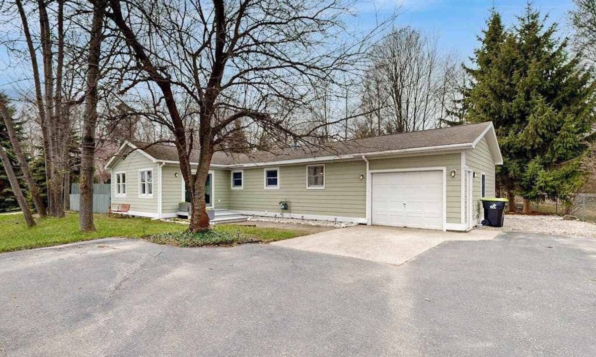 Suttons Bay House | Tranquil Lakeview Retreat in Suttons Bay, with a private sauna, & large yard
