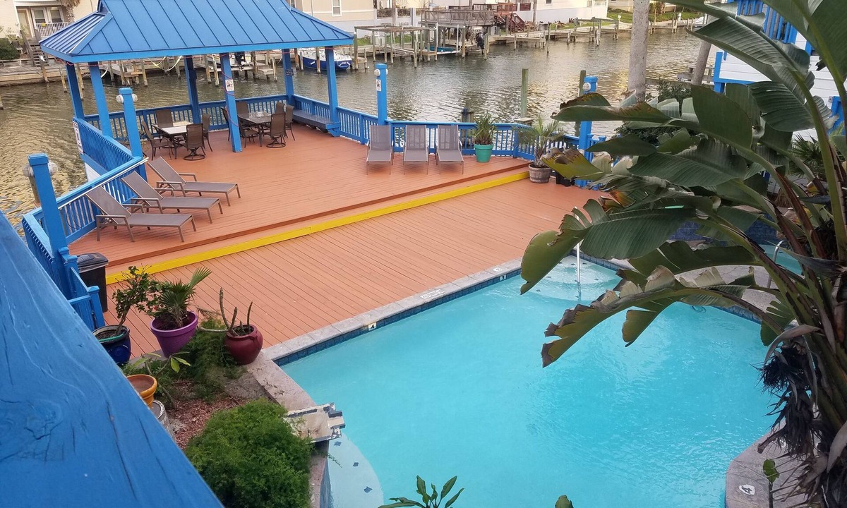 Corpus Christi Condo | Waterfront Paradise has a Reserved Boat Slip, Overlooks the Pool & the Canal