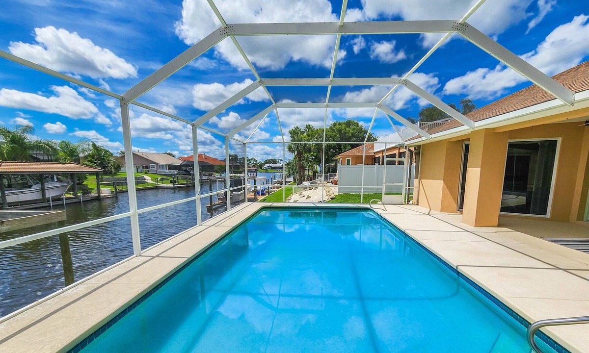 Palm Harbor House | Waterfront Pool Home | Dock | Game Room | King Bed
