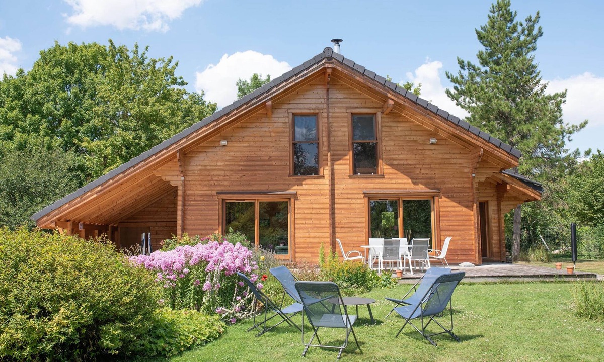 Baudement Ski Chalet | Wooden House in a green setting.