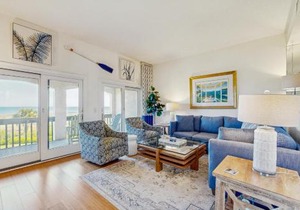 Dog-friendly oceanfront townhouse with covered balcony, views, pool & AC