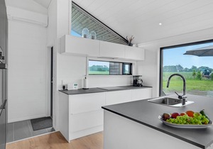 Here you can expect a modern vacation home with stylish interior and comfortable outdoor area.