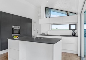 Here you can expect a modern vacation home with stylish interior and comfortable outdoor area.