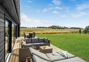 Here you can expect a modern vacation home with stylish interior and comfortable outdoor area.