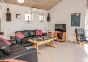 In a quiet vacation area near Lønstrup, this stone vacation home awaits you on a natural plot with p