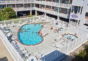 Modern, stylish 2-bedroom luxury condo with free WiFi and an outdoor pool located midtown and only one block from the beach!