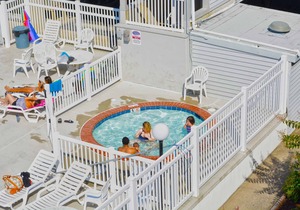 Modern, stylish 2-bedroom luxury condo with free WiFi and an outdoor pool located midtown and only one block from the beach!