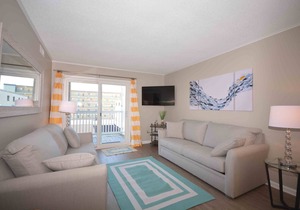 Modern, stylish 2-bedroom luxury condo with free WiFi and an outdoor pool located midtown and only one block from the beach!