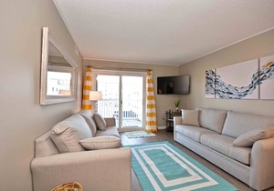 Modern, stylish 2-bedroom luxury condo with free WiFi and an outdoor pool located midtown and only one block from the beach!
