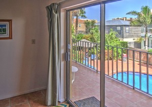 Spacious oasis near the beach with a private balcony, pool, and hot tub