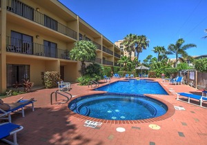 Spacious oasis near the beach with a private balcony, pool, and hot tub