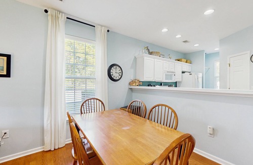 Sunset Beach Condo | 1st-floor corner condo with water view, on-site pool, & screened patio