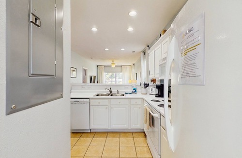 Sunset Beach Condo | 1st-floor corner condo with water view, on-site pool, & screened patio
