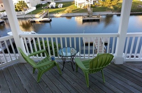 Ocean Isle Beach House | 4bd Canal Front home with an Elevator, dock, fenced back yard, 2 master suites