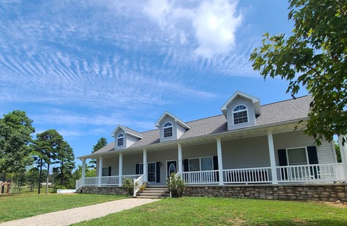 Pomona House | A large country home with scenic views of a working cattle farm & rural locale.