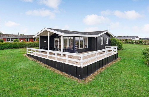 Helnæs By House | A simple cottage with terrace and bright living room.