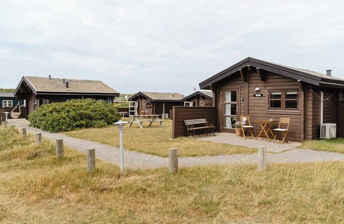 Fjand Badeby House | A small wooden hut in a large community