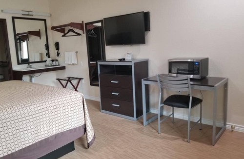 Bay City Hotel | Affordable Room w/Complimentary Breakfast, Microwave, and Full-Size Fridge