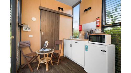 Flowerdale House | Alpaca Tiny House with Vineyard Lakeside by Tiny Away