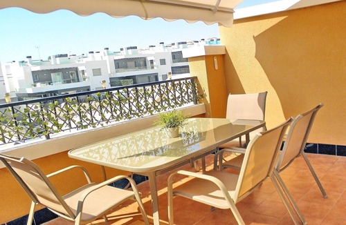 Orihuela Costa Apartment | Apartment with Large Roof Solarium, Pool, Garden, Barbecue, A/C & Wi-Fi